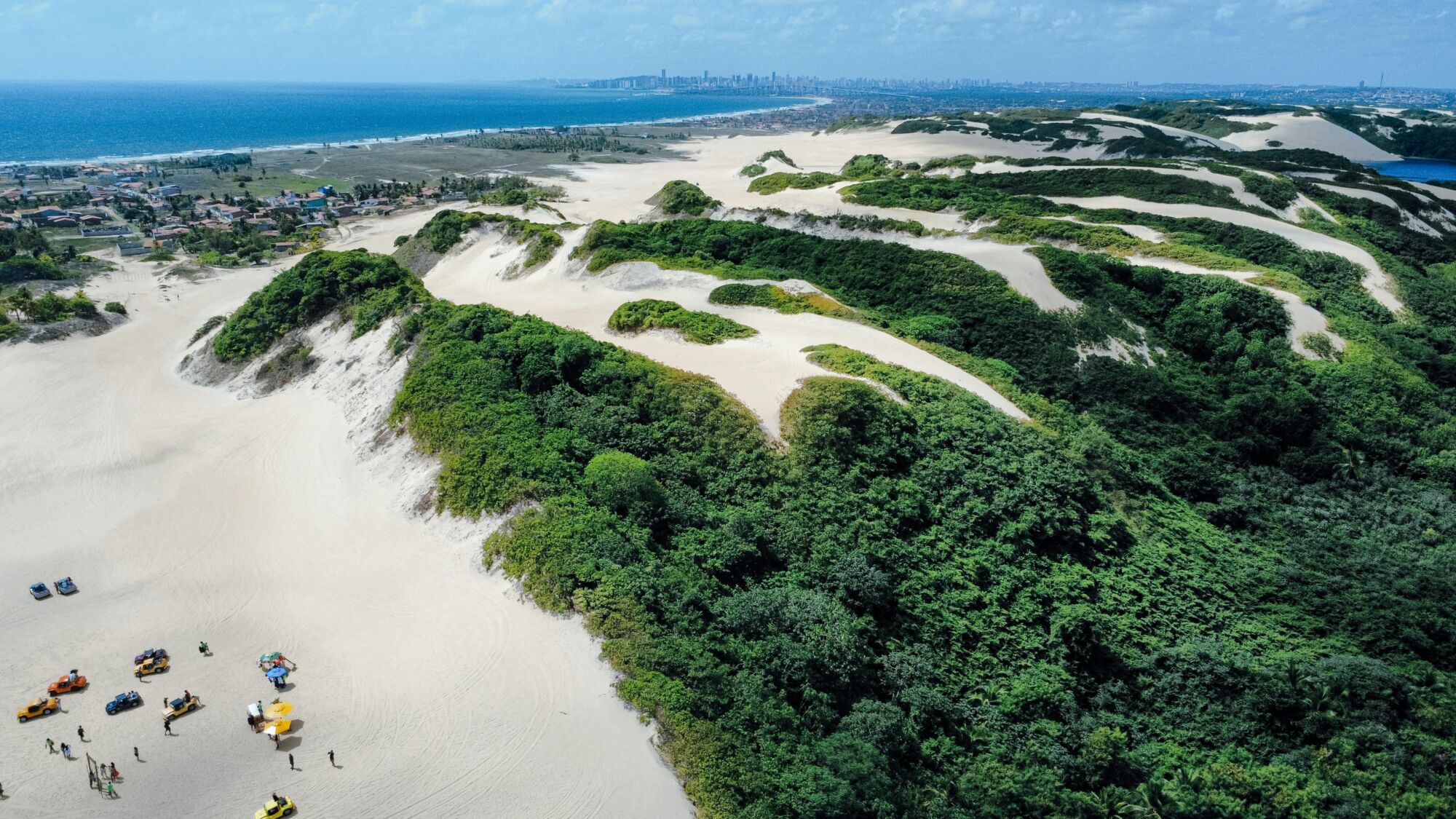 Stunning aerial view of lush green and sandy dunes in Natal, Brazil.